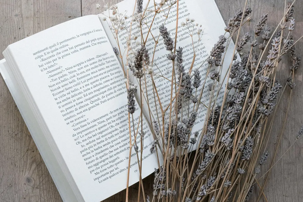 Open book with dried lavender floral over the right page of the book.