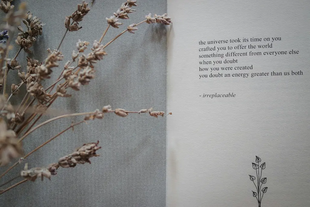 Poetry. Graphic of poem with a floral arrangement of dried flowers laying next to the book